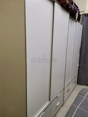 White sliding-door wardrobe with drawers — good condition