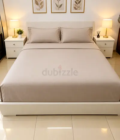 White IKEA bed frame with headboard and two bedside tables - good condition.