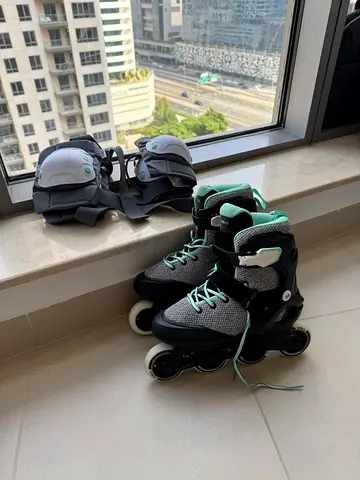 Pair of adult inline roller skates (size 38) with protective gear - lightly used