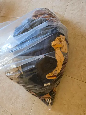 Bag of assorted used clothing - mixed items, good for donation or resale