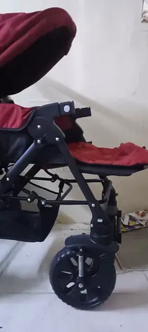 Used red baby stroller / pram in good working condition