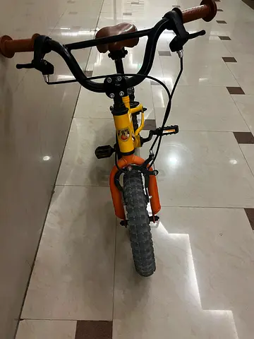 Kids' orange and yellow  bicycle works perfectly fine used for 1 half months flawless