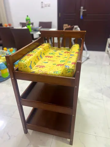 Wooden baby changing table with cushioned mat