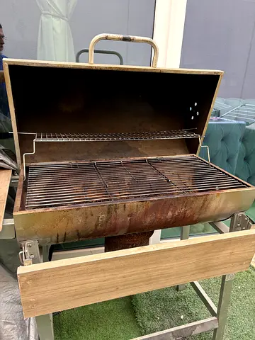 Used charcoal BBQ grill with side wooden shelf — sturdy and functional