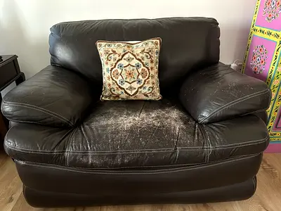2 Used dark brown leather 1-seater armchair. One of them is in good condition.