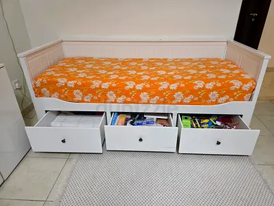White wooden daybed with 3 under-bed storage drawers