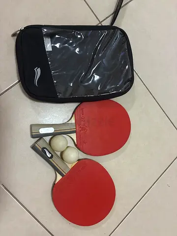 Like new pair of table tennis paddles with 8 balls and carry case