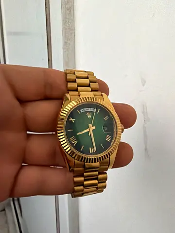 Gold-tone men's wristwatch with green dial