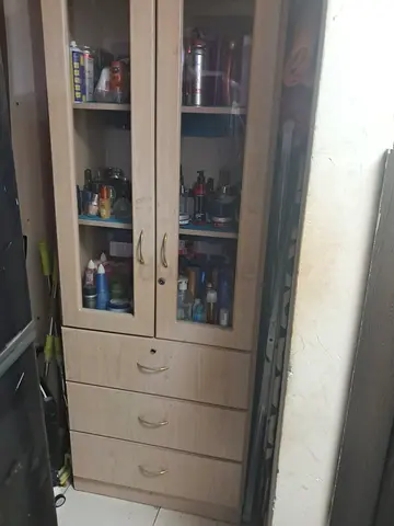 Wooden storage cabinet with glass doors and 3 drawers
