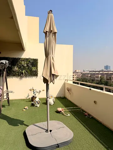 Large outdoor patio umbrella with base - good condition (leaving must sell everything)
