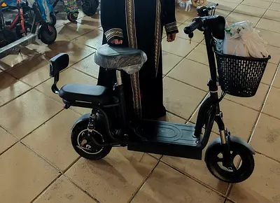 Electric scooter with padded seat, rear passenger seat and front basket - good condition