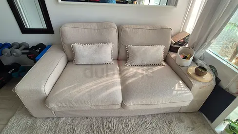 Light beige 2-seater fabric sofa in good condition