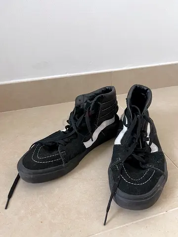 Black high-top sneakers with white side stripe, size not specified