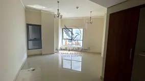 Two-bedroom apartment with a living room, balcony, maid's room, laundry room, and an open view acros
