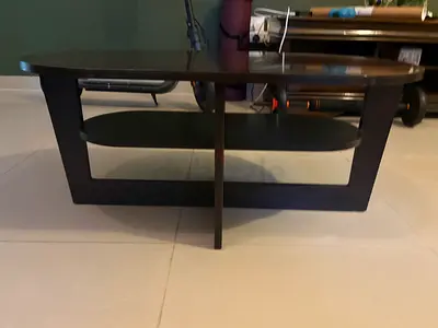 Dark wood oval coffee table with lower shelf — perfect condition
