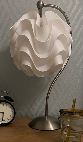 Curvy white sculptural bedside table lamp with brushed metal stand