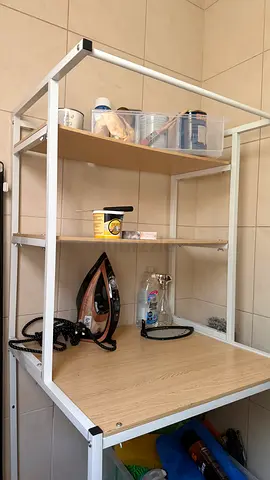 White metal shelving unit with wooden shelves - compact utility rack can be used for laundry