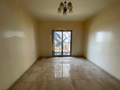 One-bedroom apartment for annual rent in Ajman, Al Rashidiya 1 area, featuring a prime location next to Al Rawabi Market and behind Pearl Towers.