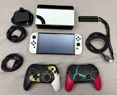 Nintendo Switch OLED with 2 Pro Controllers, dock, cables and straps