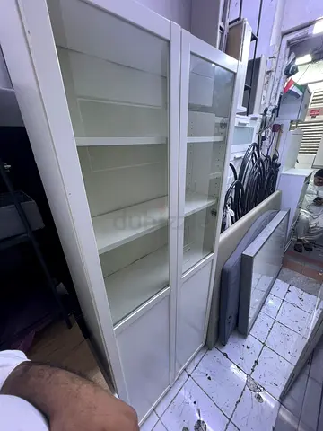 White tall glass-front cabinet / bookshelf - good condition