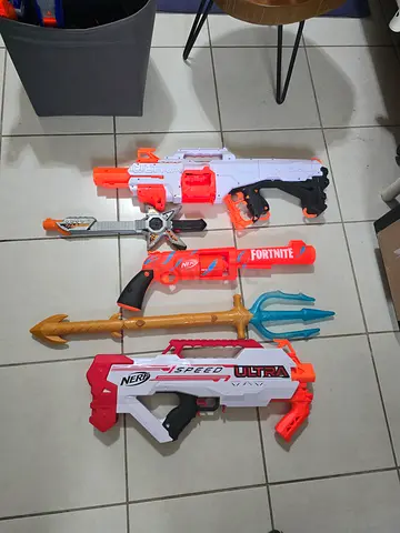 Collection of Nerf and Fortnite toy guns with trident - used