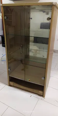 Wooden display cabinet with glass doors and shelves - good condition.
