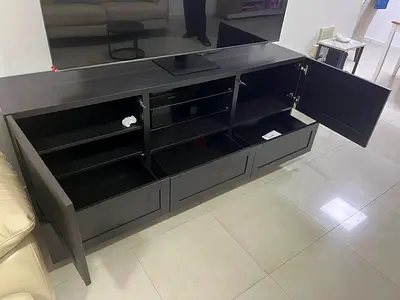 Dark wood TV entertainment unit with storage drawers and cabinets