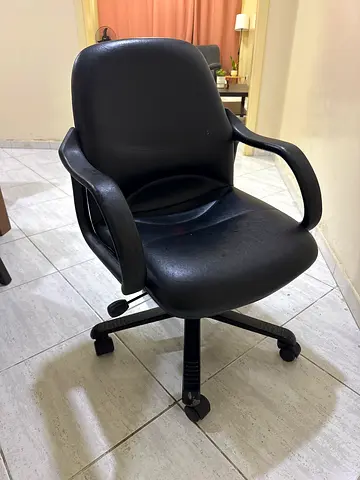Black ergonomic office chair with armrests and wheels - used