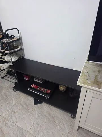 Low black TV stand / entertainment unit on wheels - good condition