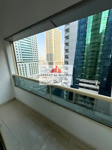 Two-bedroom apartment with a living room in Al Taawun; features a view of the roundabout and a balc