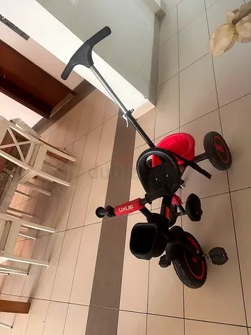 Red toddler push tricycle with parent handle - excellent condition