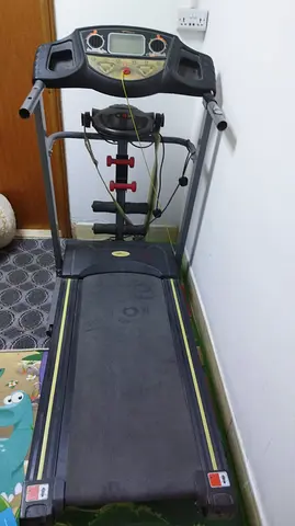 Used motorized treadmill with dumbbell set — good working condition