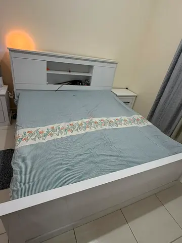 White king bed frame with headboard storage and bedside table