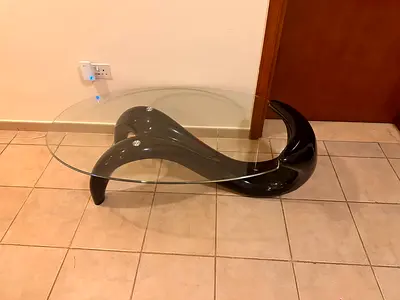 Modern Sculptural Glass Top Coffee Table with Curved Black Base
