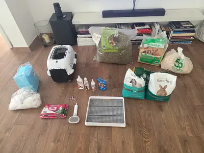 Small rabbit/rodent starter bundle — carrier, food, hay, litter & accessories
