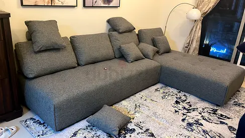 Modern L-shaped Grey Green Sofa-cum-Bed with chaise. From Home Centre.