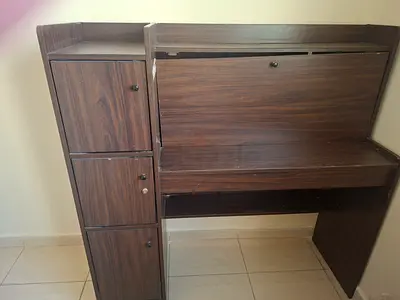 Wooden study desk with storage compartments and pull-down writing surface