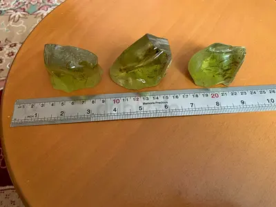 Three natural green glassy stones with internal inclusions — approx 3–4 cm each