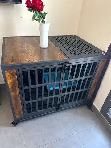 Large wooden and metal dog crate on wheels. Double door and top door. Removable tray below the crate
