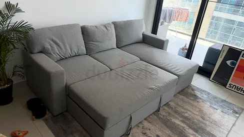 Light grey L-shaped sofa bed with chaise -