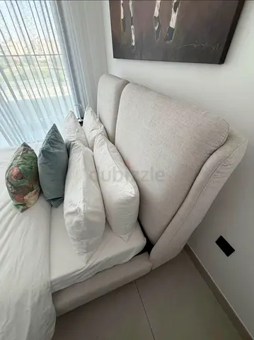Light grey upholstered queen bed and mattress with padded headboard — excellent condition