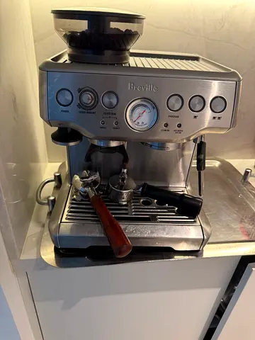 Breville stainless steel espresso machine with portafilter and grinder