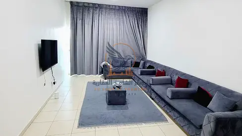 Furnished two-bedroom apartment with a living room, excellent space, balcony with an open view, available for monthly rent in Ajman.