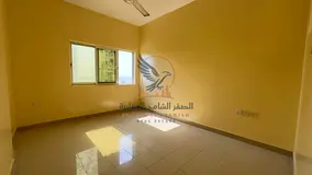 Two-bedroom apartment with a living room in Ajman Industrial Area 2, behind Emirates Markets, with a