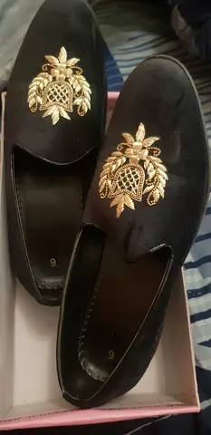 Black velvet slip-on loafers with gold embroidered crest - size 9