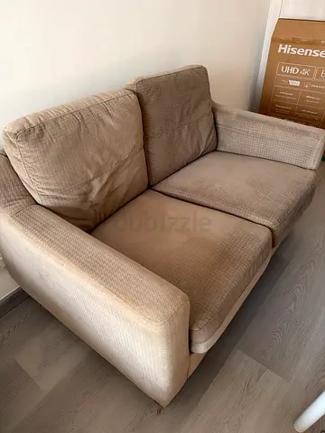 2-seater beige fabric sofa in good used condition