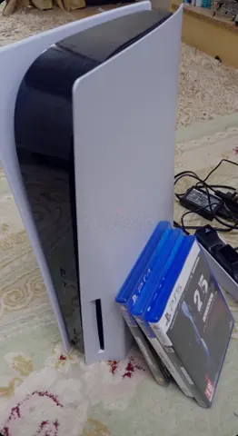 ps5 with controller and 3 games and a wireless charger stand