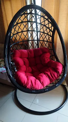 Black rattan egg hanging chair with red cushion