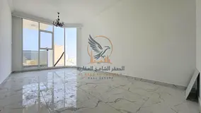 Two-bedroom apartment with a living room, sea view, and private parking for annual rent in Al Nakhee