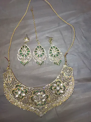 Gold-tone kundan necklace set with matching earrings (green accents)